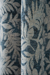 Macro view of blue coconut jacquard fabric with vintage floral weave and thick texture