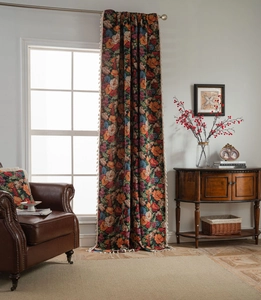 Detail of floral jacquard curtain with elegant cream tassels and matching pillow