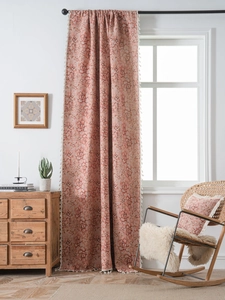 Detail of terracotta floral curtain with white fringe tassels and matching cushion set
