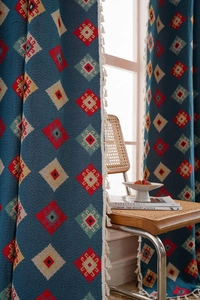 Detail of blue geometric jacquard curtain with elegant white decorative tassels