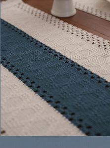 Detailed macro view of Nordic hand-woven cotton table runner with navy blue stripe patterns