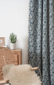 Detailed blue jacquard curtain fabric with vintage leaf patterns and beige tassel fringe