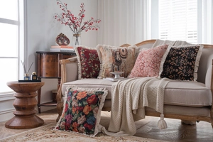 Close-up of decorative jacquard throw pillow covers with elegant fringe trim on a sofa