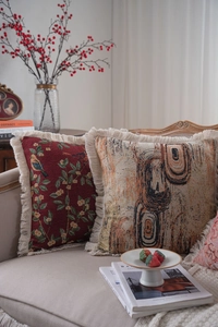 Close-up of vintage jacquard pillowcases with floral bird patterns and beige tassels