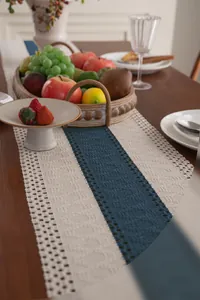 Close-up detail of crochet hollow-out table runner with blue and white contrast weave