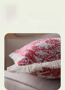 Detail shot of the American jacquard pillow cover with red floral print and white tassels