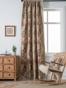 Detail of bohemian long curtain with concentric rings pattern and white fringe tassels