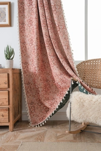 Close-up of bohemian floral jacquard fabric with elegant white fringe tassel detail