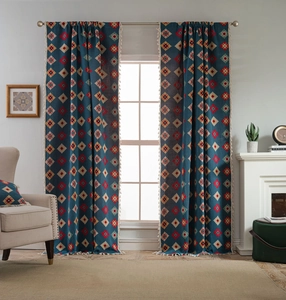 Detail view of blue bohemian curtains with geometric patterns and white tassels
