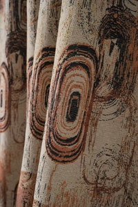 Close-up of retro jacquard fabric with textured tree ring patterns and abstract geometry