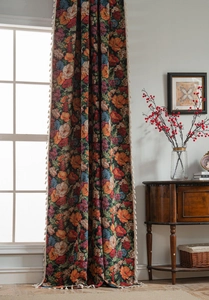 Detailed close-up of retro floral curtains with elegant cream fringe and tassel trim