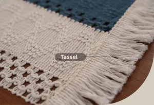 Macro shot of boho navy and cream woven table runner with intricate fringe tassels