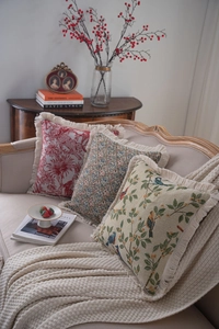 Detailed close-up of jacquard throw pillows featuring vintage patterns and elegant tassel edges