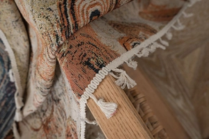 Close-up of jacquard textured curtain featuring tiger animal patterns and white cotton tassels