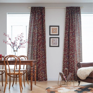 Retro red curtains with floral and bird patterns and beige tassel trim for a vintage look