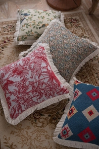 Detailed close-up of American jacquard throw pillow covers with decorative tassels
