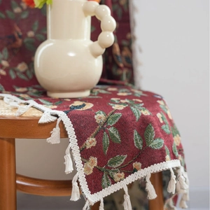Red jacquard curtain with bird and floral patterns and elegant white fringe tassels