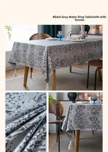 Detailed close-up of dark grey jacquard tablecloth fabric texture and cream white tassels