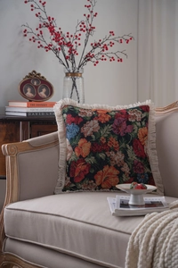 Close-up of vintage floral jacquard pillow cover featuring elegant cream fringe details
