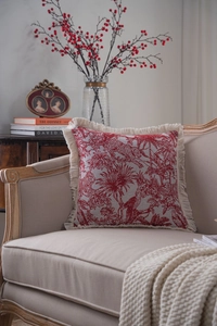 Detailed view of beige and red Toile de Jouy jacquard pillow with elegant fringed edges