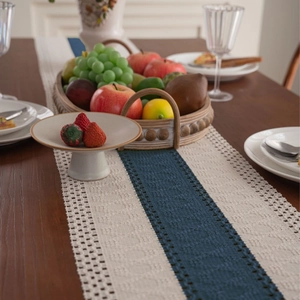 Nordic woven table runner with navy blue contrast stripes and tassel fringe decorations
