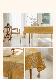 Detail of yellow jacquard tablecloth with white drop pattern and fringe tassels