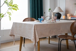 Detail of European jacquard tablecloth with damask patterns and elegant corner tassels