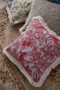 Close-up of vintage American jacquard cushion covers with tassels and retro floral patterns