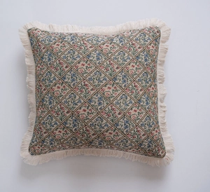 Detail of American style jacquard floral throw pillow with elegant beige fringe edges