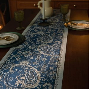 Blue Paisley table runner with white floral jacquard on dark wood dining table