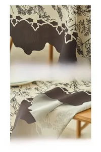 Detail of waterproof polyester tablecloth with floral patterns and scalloped edges