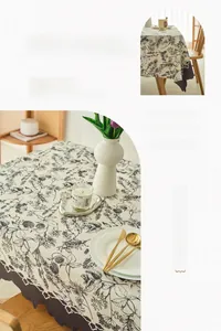 Detail of French cream tablecloth featuring floral patterns and scalloped lace edges