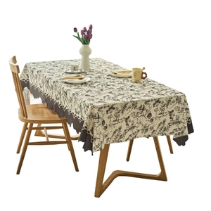 Cream rectangular tablecloth with floral patterns and dark grey wavy scalloped edges