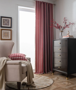 Macro shot of red and white geometric jacquard curtains with elegant fringe edge details