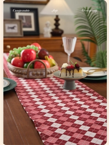 Macro shot of red and white checkered table runner with high-density woven texture fabric