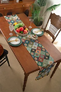 Close-up of vintage geometric jacquard table runner with colorful handcrafted tassels