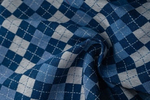 Detailed macro view of French blue checkered jacquard fabric with woven diamond patterns