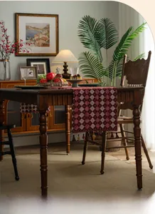 Detail of American retro table runner with red and white jacquard pattern and tassels