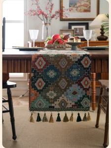 Close-up of geometric jacquard table runner with bohemian patterns and fringe tassels