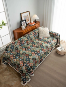 Detail of bohemian geometric diamond pattern sofa cover with soft white tassel fringes