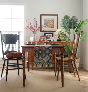 Close-up of Bohemian geometric jacquard table runner with decorative tassel details