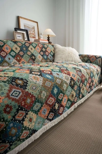 Detail of colorful geometric jacquard sofa throw with dense knit texture and fringe edge