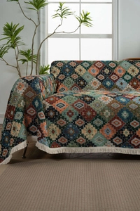 Macro view of bohemian jacquard woven blanket with geometric patterns and white fringe
