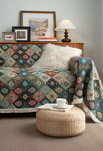 Detail of colorful geometric woven throw blanket with thick fringe and bohemian pattern
