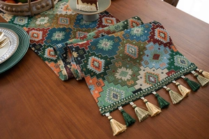 Detailed view of bohemian jacquard table runner with geometric patterns and fringe