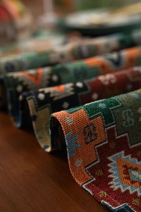 Close-up of retro jacquard table runner showing colorful geometric weave and thick texture