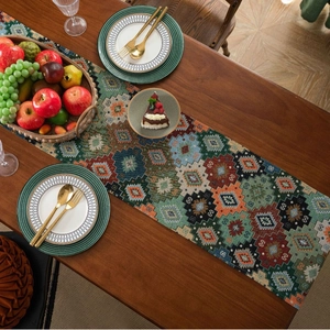 Vintage geometric jacquard table runner with bohemian tassels on wooden table