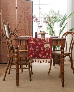 Close-up of red Chinese New Year table runner with jacquard patterns and silk tassels