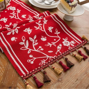 Red jacquard table runner with bird floral pattern and tassels for holiday table decor