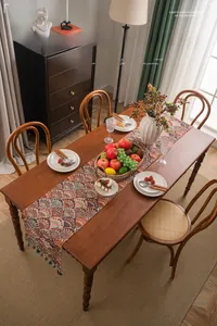 Detail of bohemian table runner featuring ginkgo leaf pattern and handmade tassels